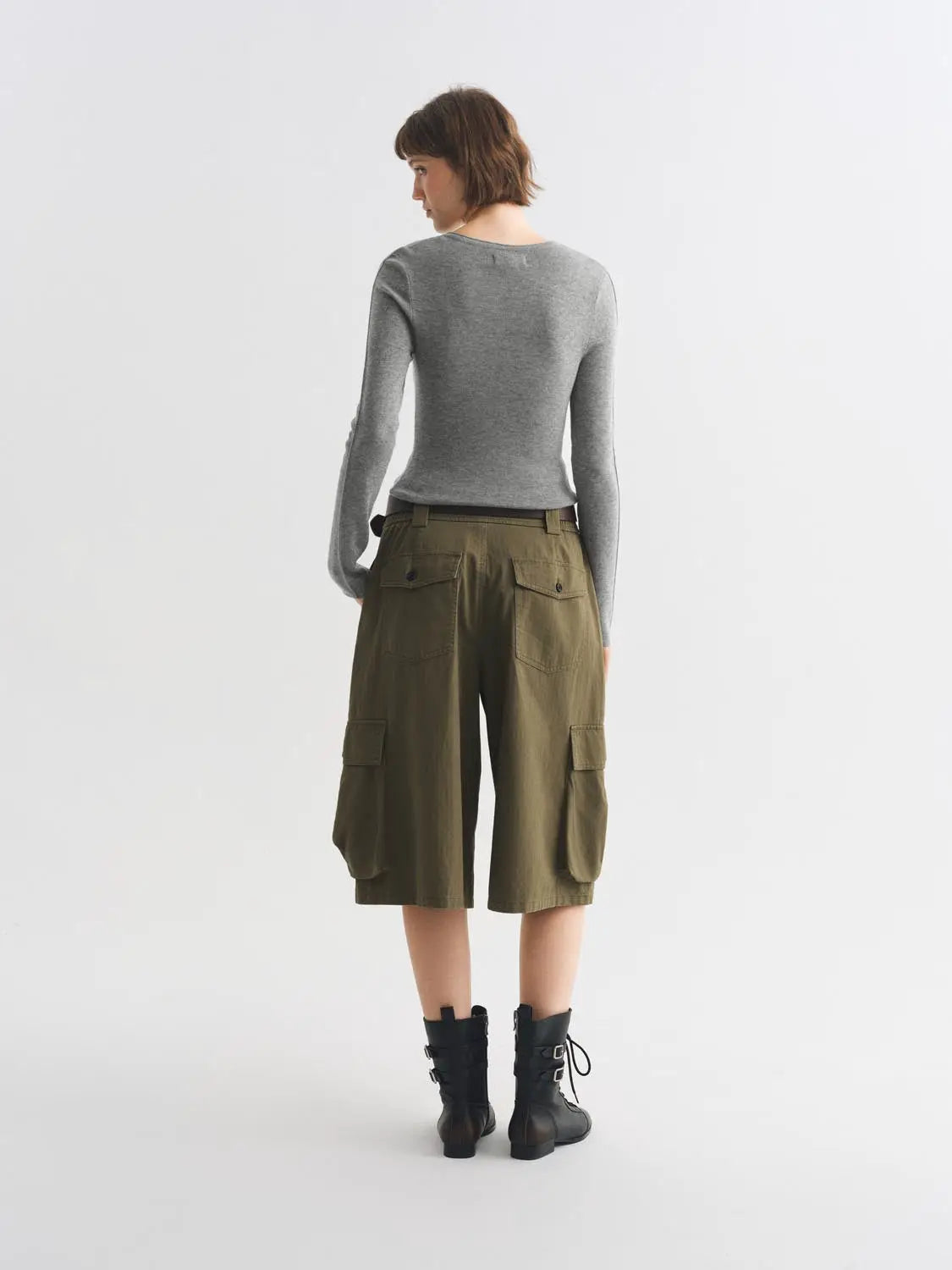 Knit T-Shirt; gray knitted top with olive cargo shorts, back view of model