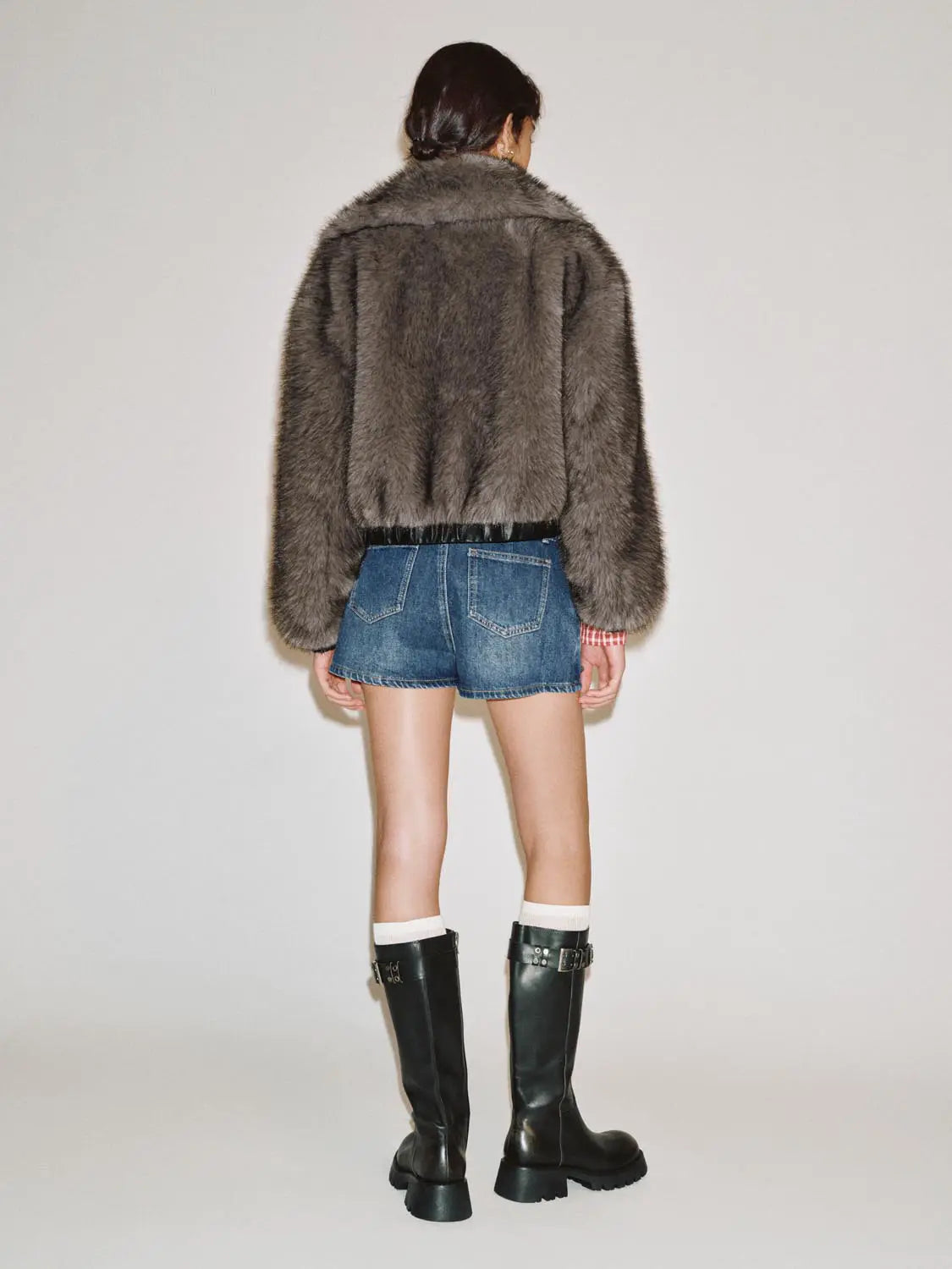 Fur coat Urban Revivo Fashion in grey-brown fur, back view of model wearing denim shorts and knee-high boots.