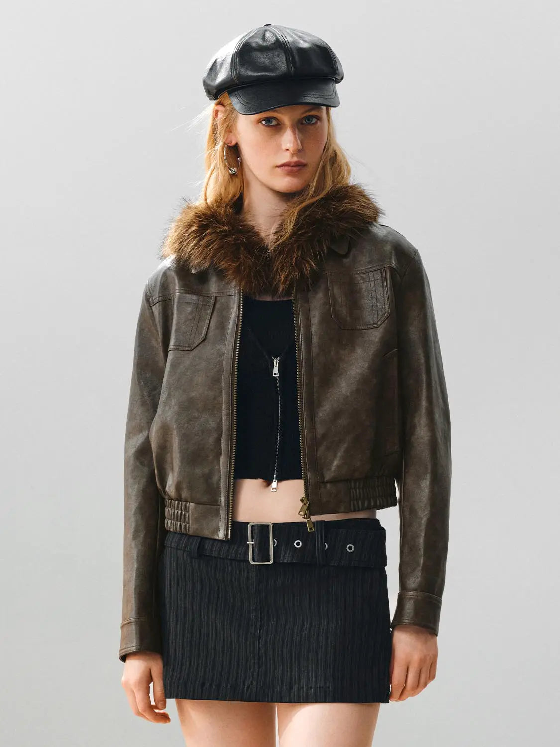 Leather jacket with brown fur collar, distressed brown leather, zip front, cropped hem, two chest pockets.