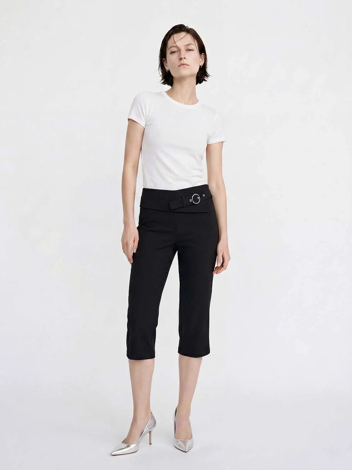 Women's black straight pants with a wide belt and metal buckle, cropped length