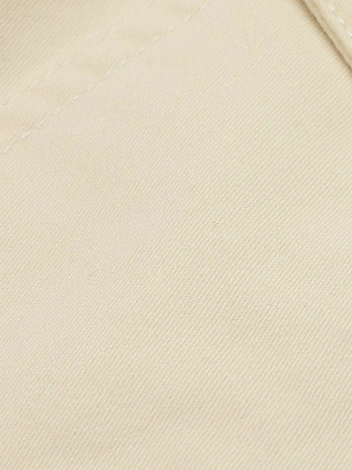 Beige cotton-stretch cargo shorts fabric close-up showing twill texture
