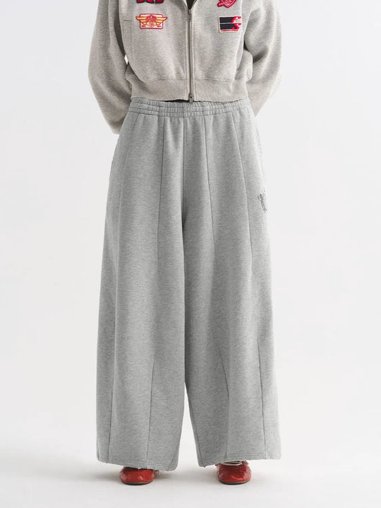Pantalon en coton à entrejambe bas et jambes larges, plis et taille élastiquée
