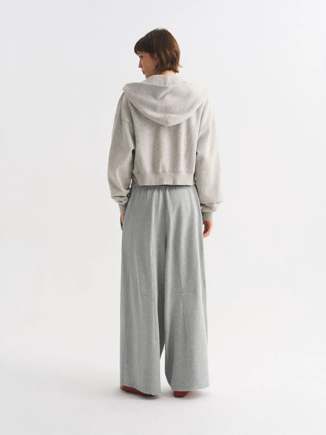 Harem pants in light gray with a wide-leg silhouette; two-piece outfit with a matching gray hoodie.