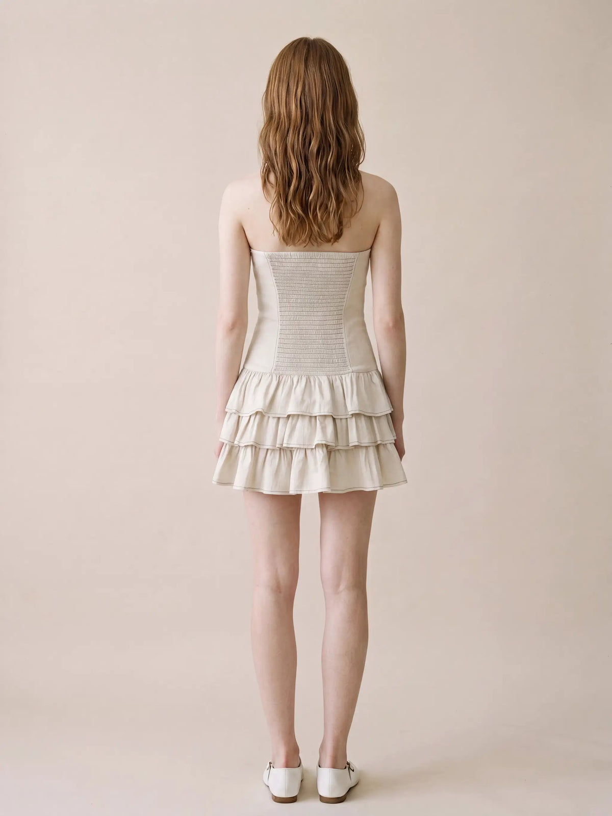 Strapless Corset Bodice Tiered Hem Cotton Linen Dress in cream, back view on model.