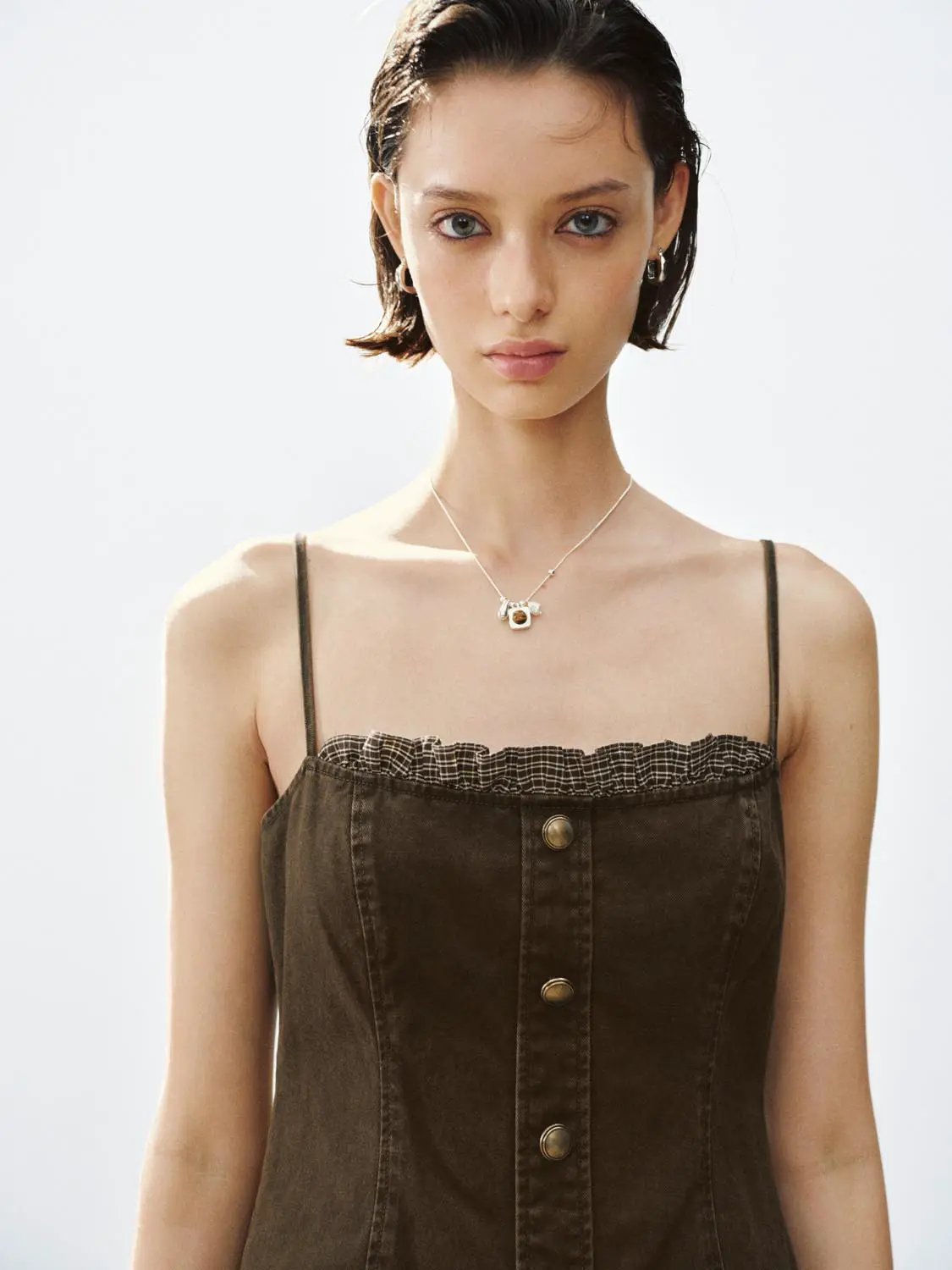 A-Line dress in olive-brown with spaghetti straps, front button placket, and ruffled neckline.