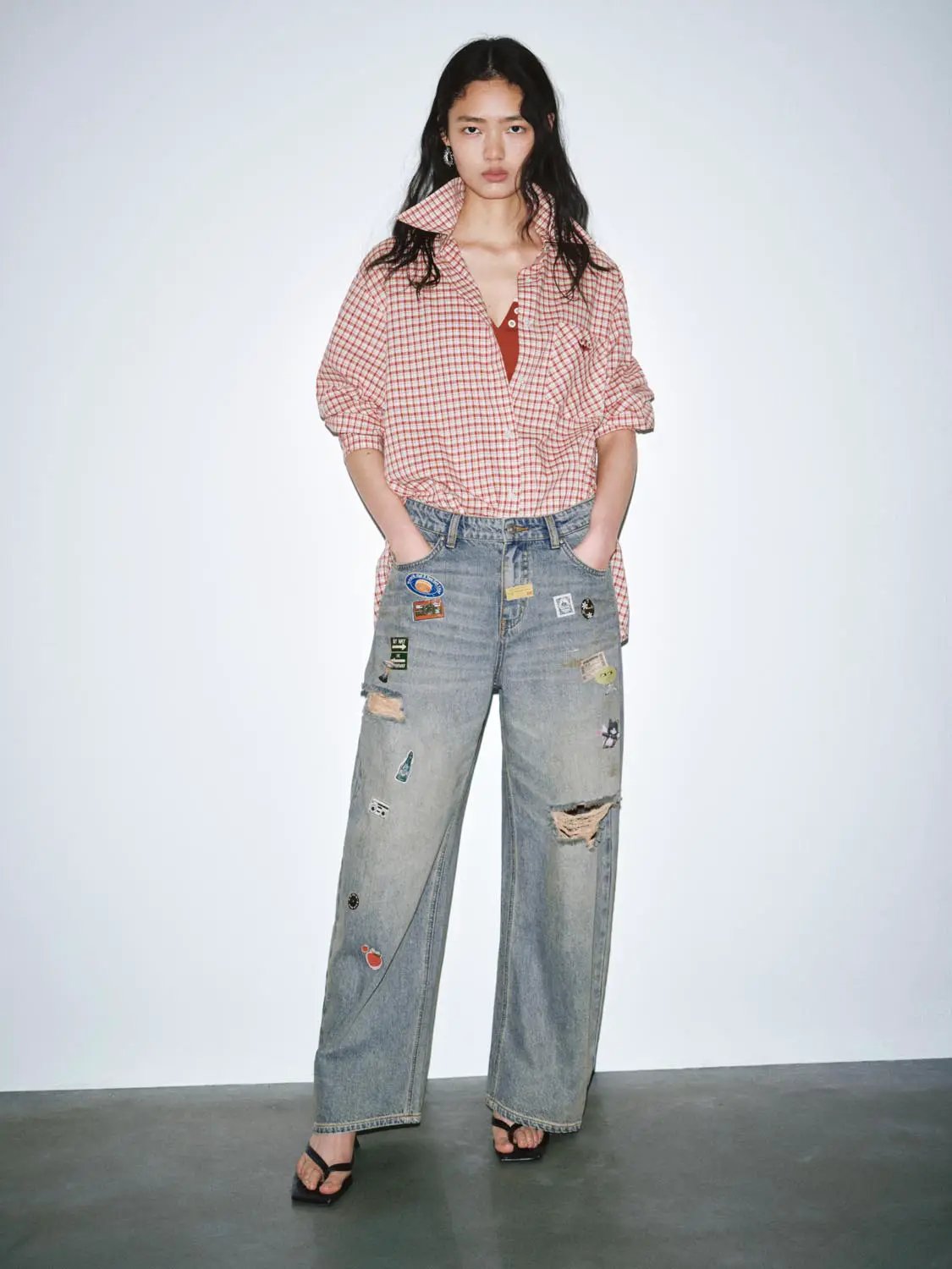 Patchwork raw-detail barrel-leg jeans in light-wash denim with assorted patches