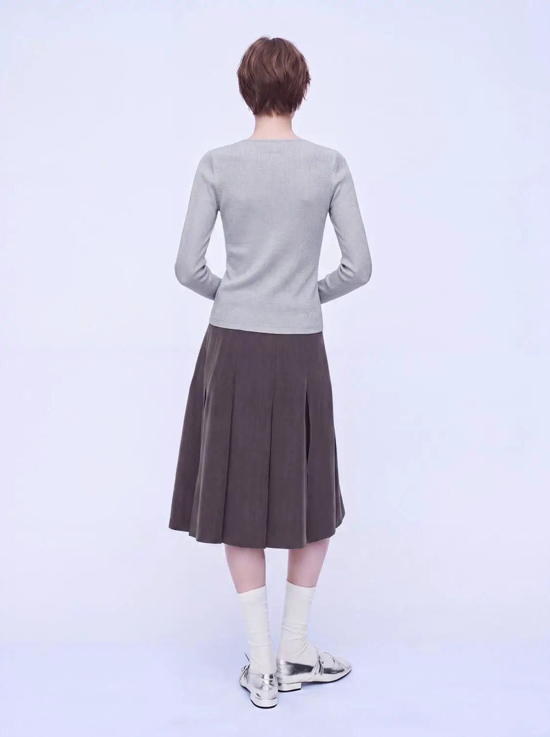 Zip Through Knitted Cardigans, light gray knit cardigan on a model paired with a brown pleated midi skirt