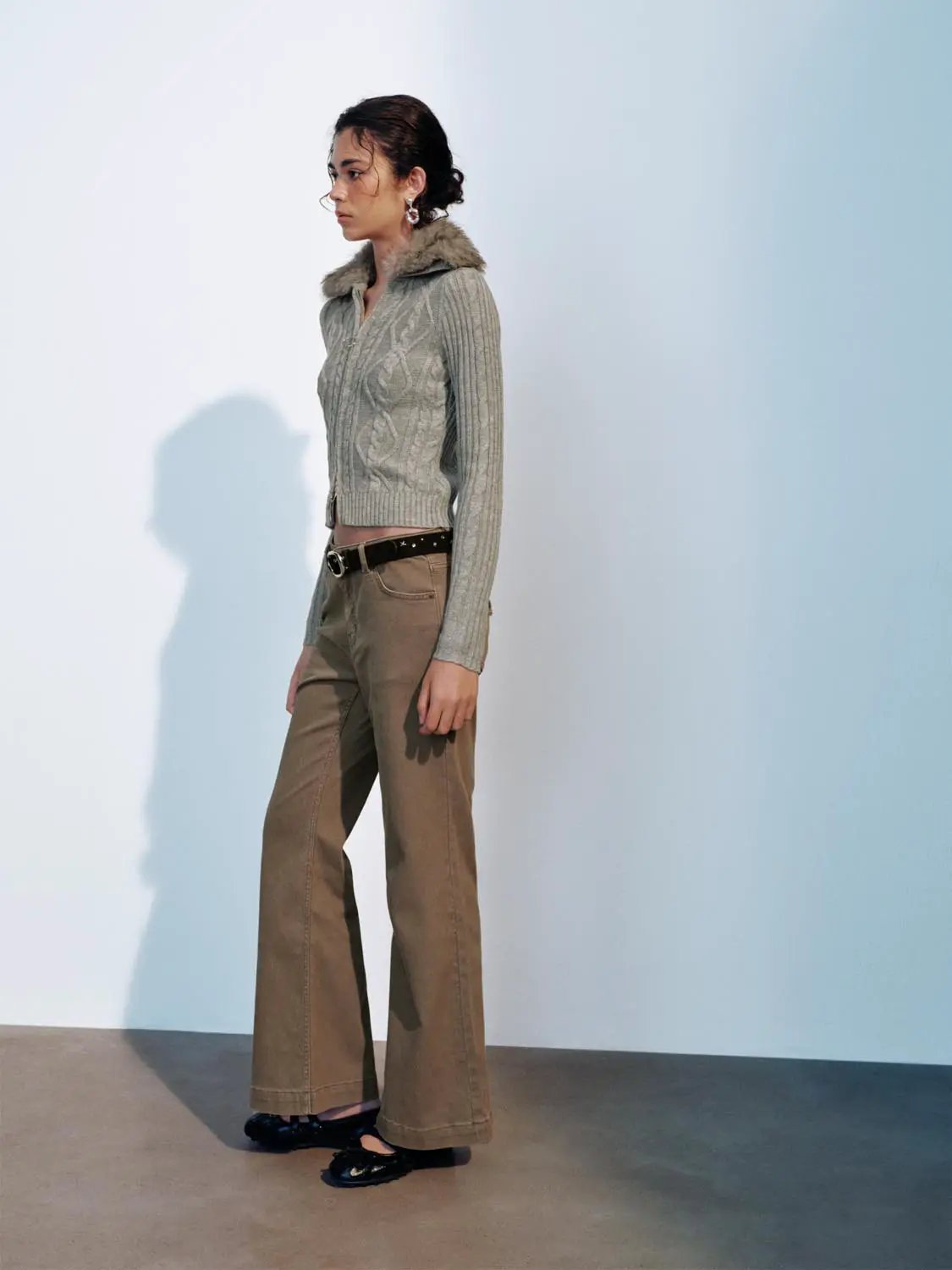 Knit jacket in grey with faux fur collar, cropped at waist, paired with khaki pants.