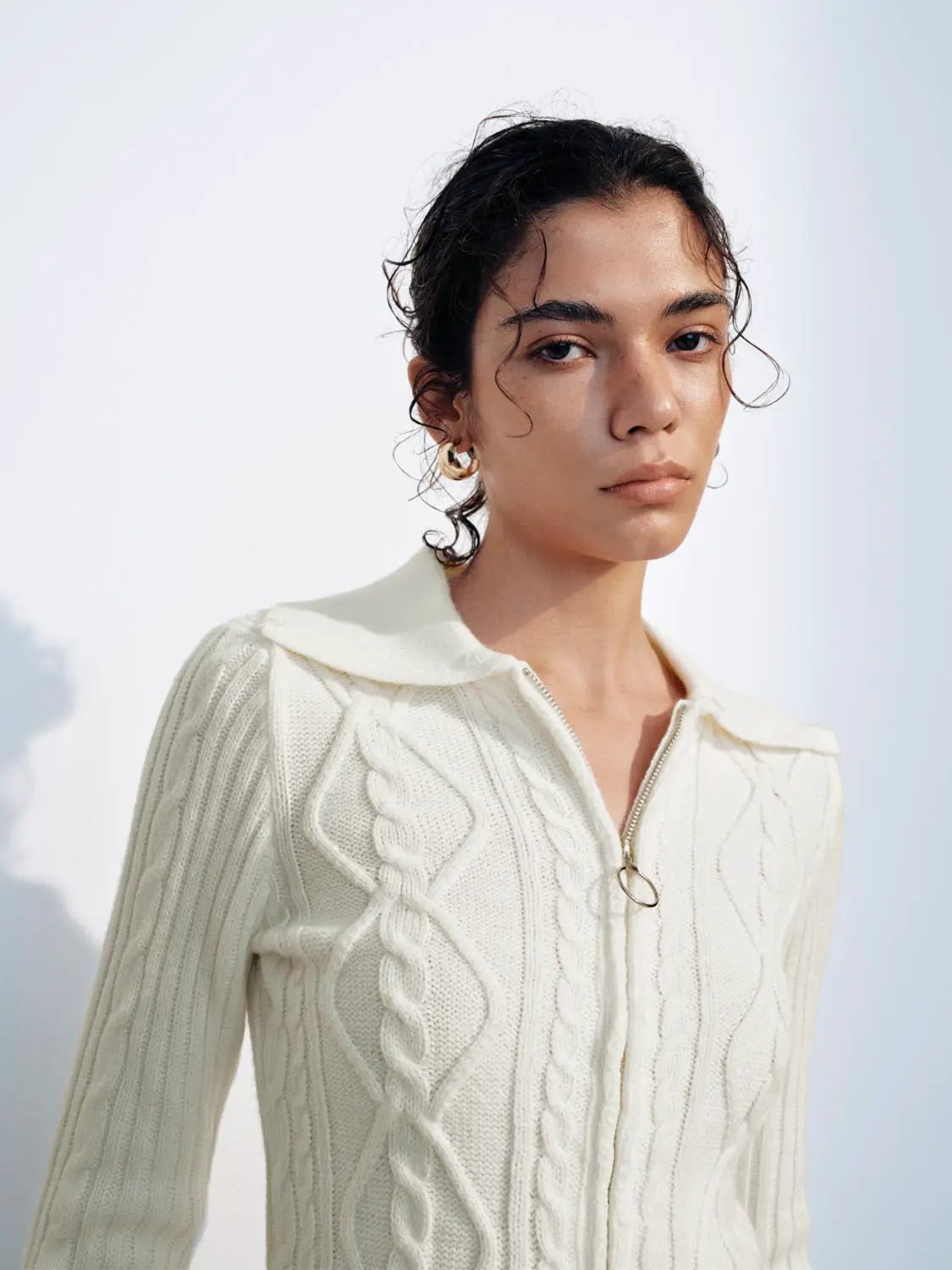 Knit cardigan in cream with cable-knit pattern and zip-front closure