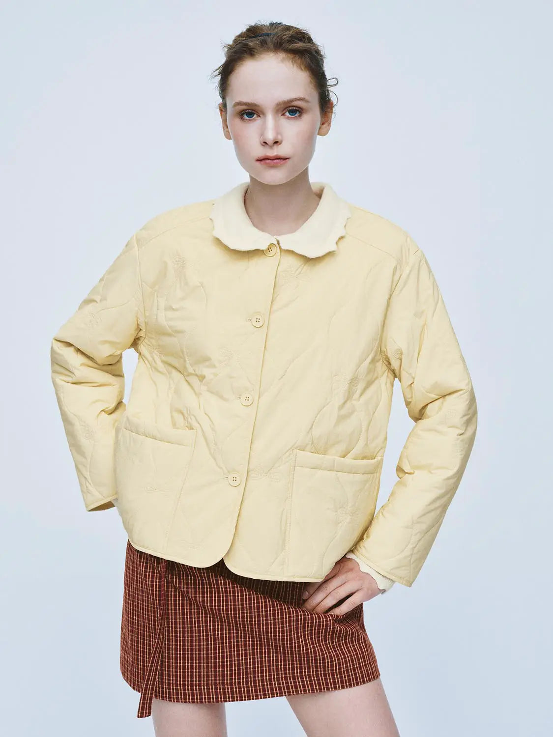 Padded jacket pale yellow with cream collar, quilted pattern, button-front, large pockets.