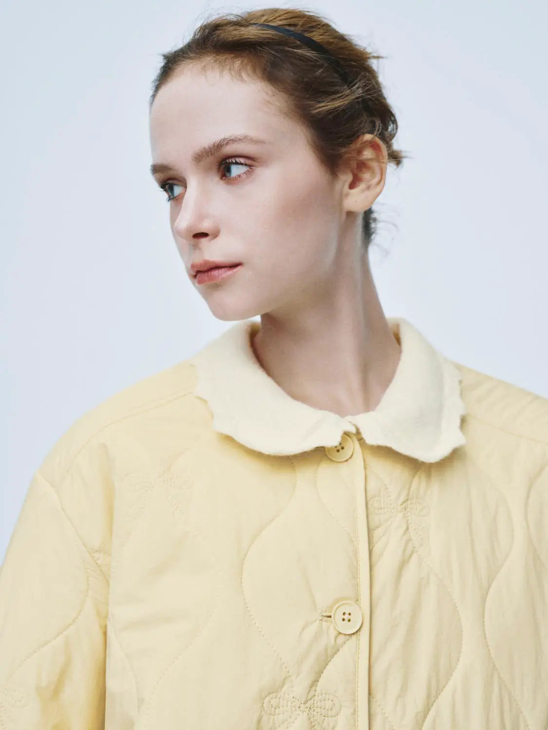Padded Jacket in pale yellow with cream shearling collar and quilted pattern.