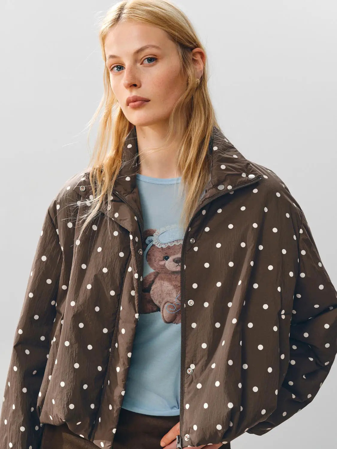 Padded Jacket brown with white polka dots; layered over a light blue teddy bear graphic tee.
