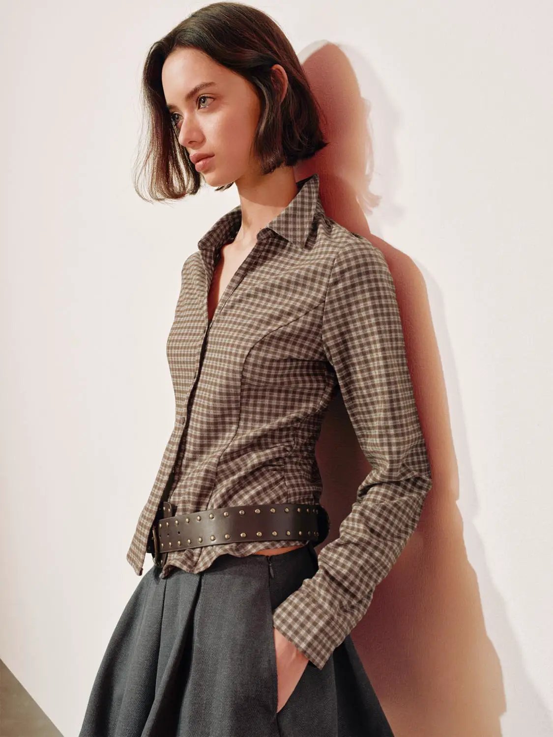 Button-front shirt in brown checked plaid, collared, long sleeves.