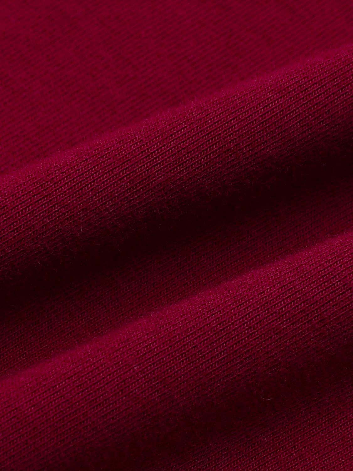 Cotton jersey knit T-shirt fabric in burgundy with visible knit texture