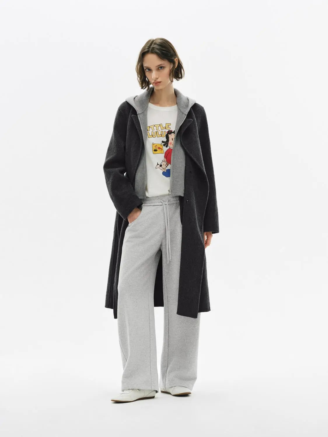 Barrel-Leg Pants in light grey with drawstring waist, paired with a long black coat.