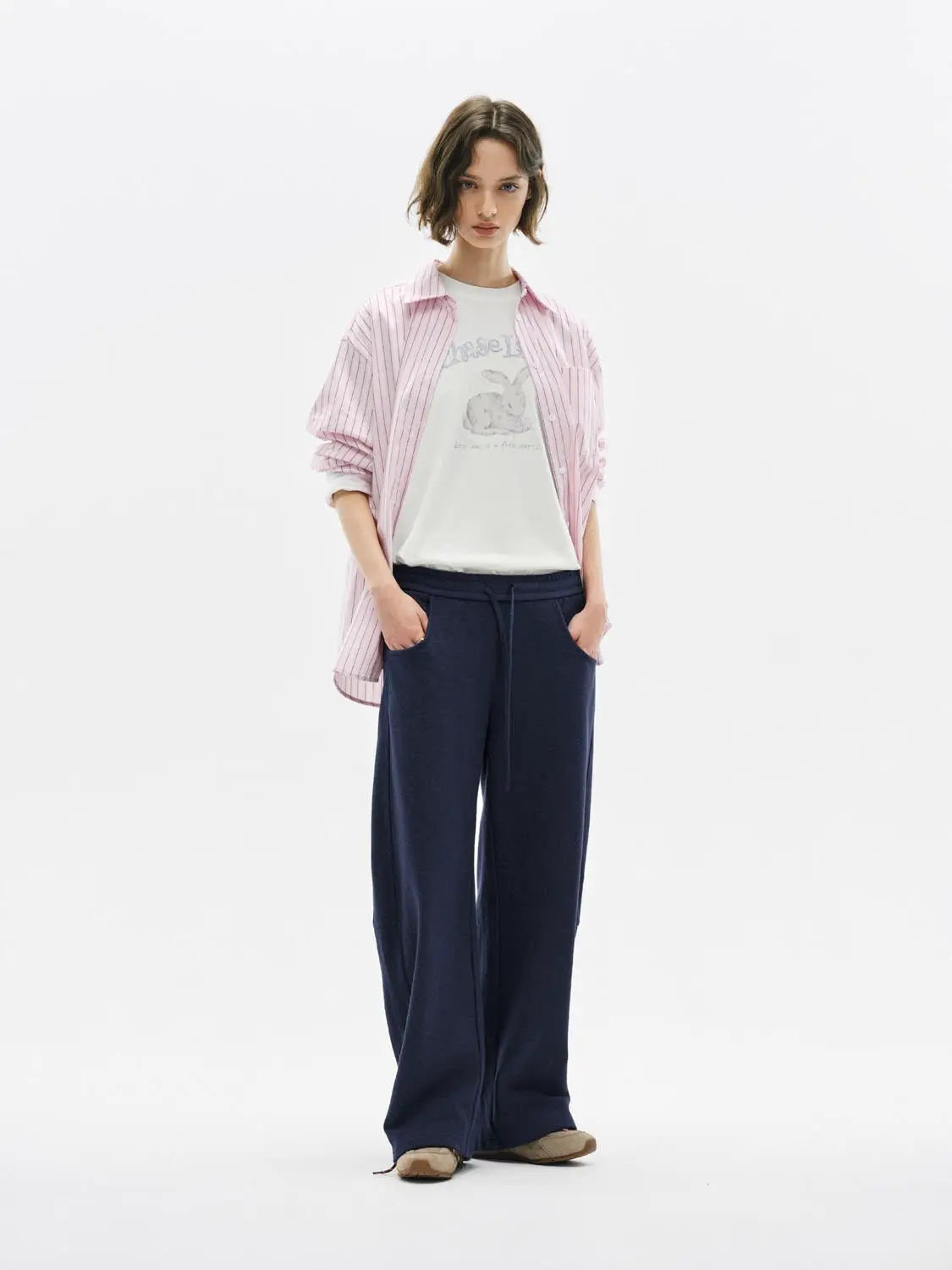Barrel-leg pants in navy with a drawstring waist, wide-leg style.