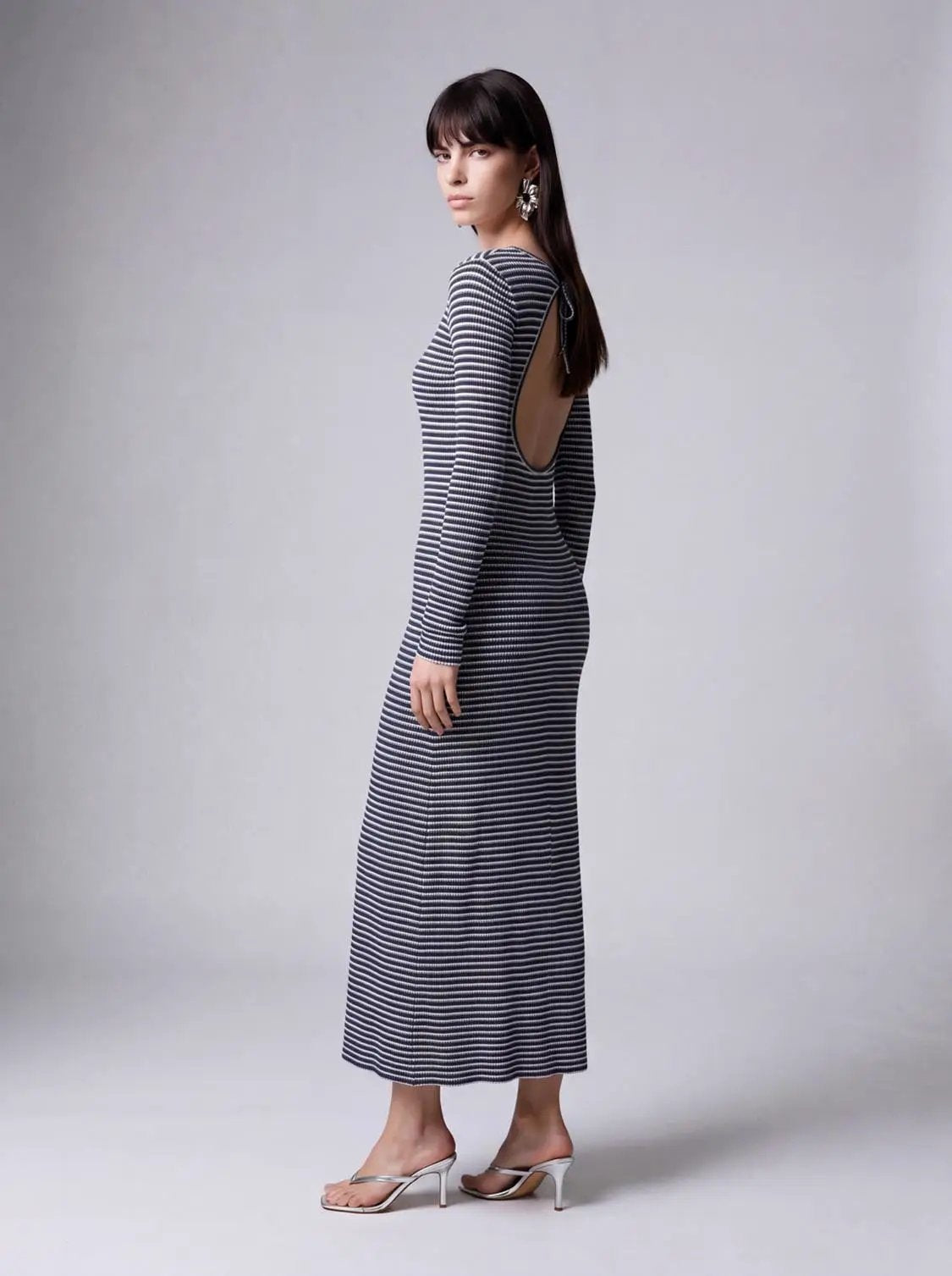 Back-cut striped maxi dress by Urban Revivo Fashion; navy and white stripes, open back with tie detail, on model.
