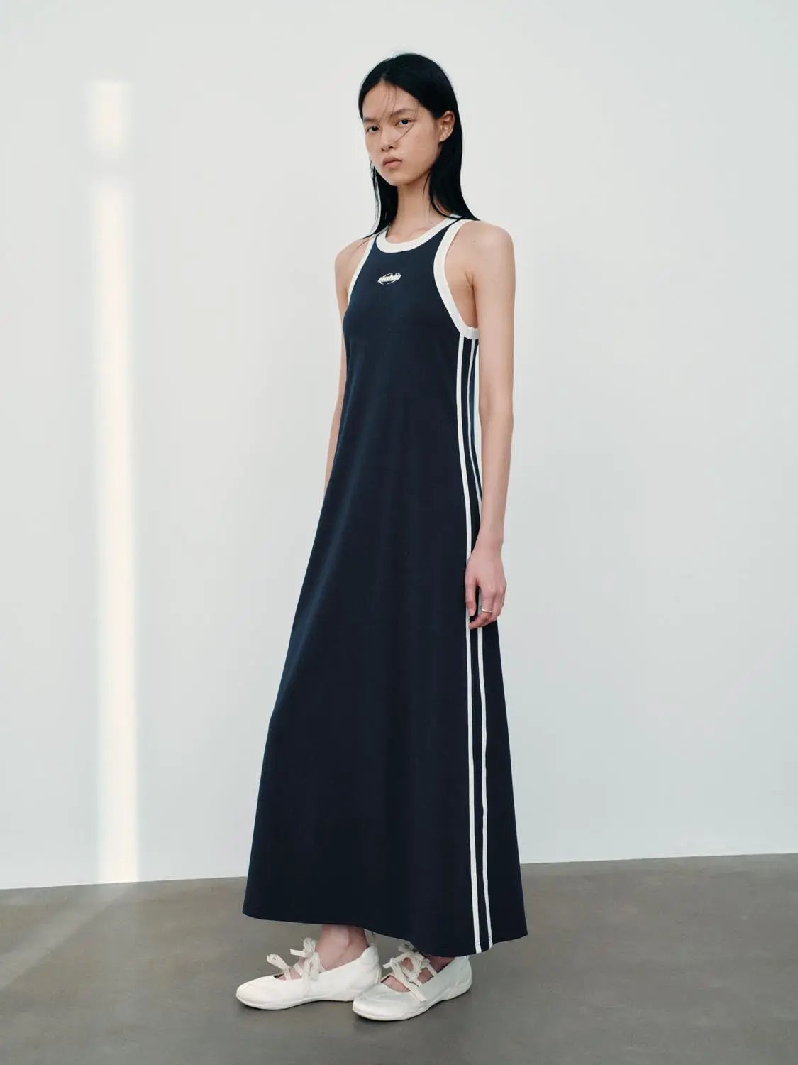 H-line navy cotton dress with white side stripes and white trim, sleeveless
