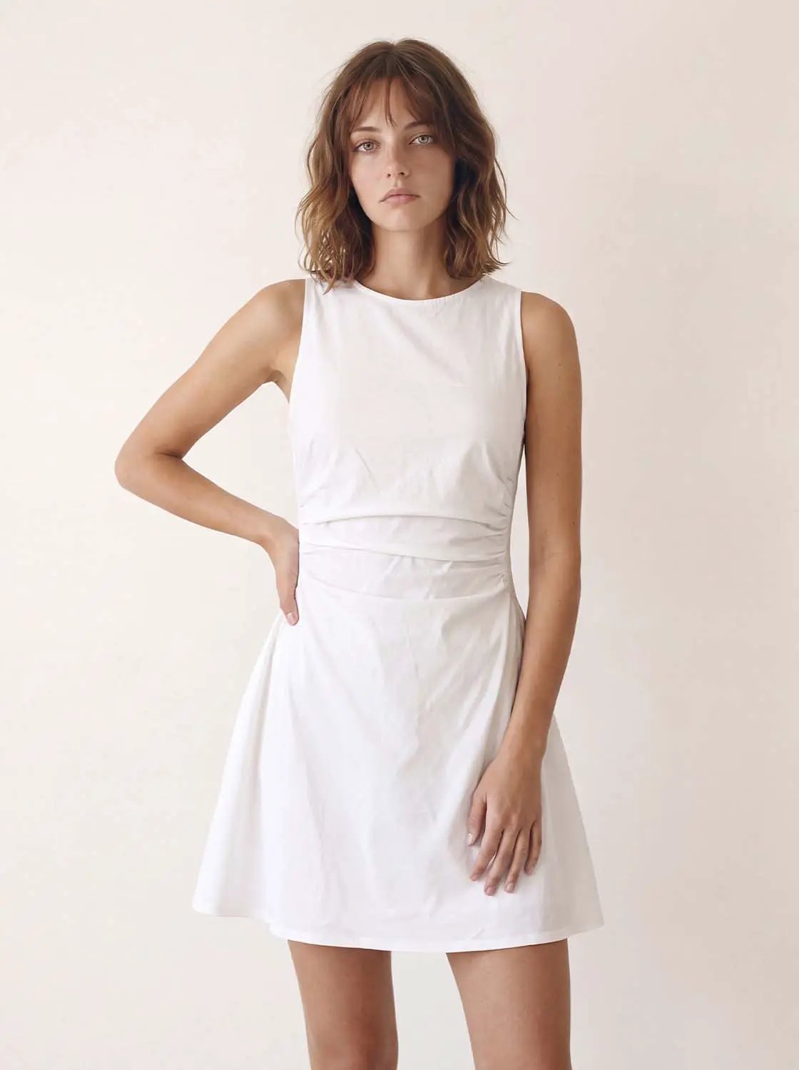 A-line dress, white sleeveless with wrapped waist detail, knee-length