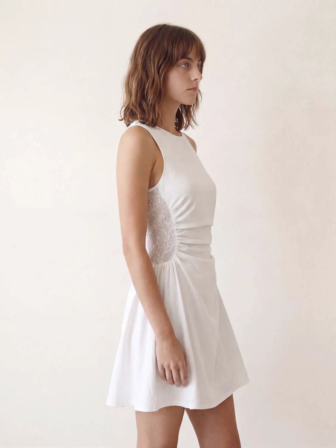 A-Line Dress in white with lace side panels, sleeveless and knee-length for an elegant daytime look