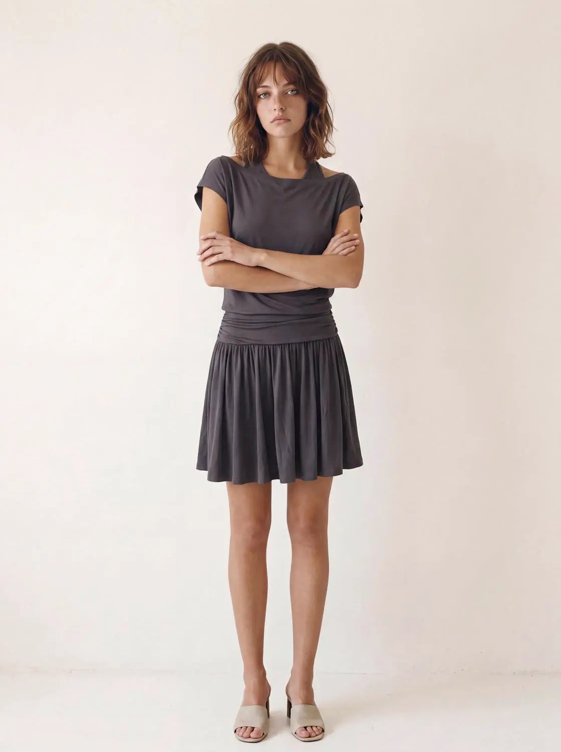 A-Line dress in gray with short sleeves, ruched waistband and pleated skirt.