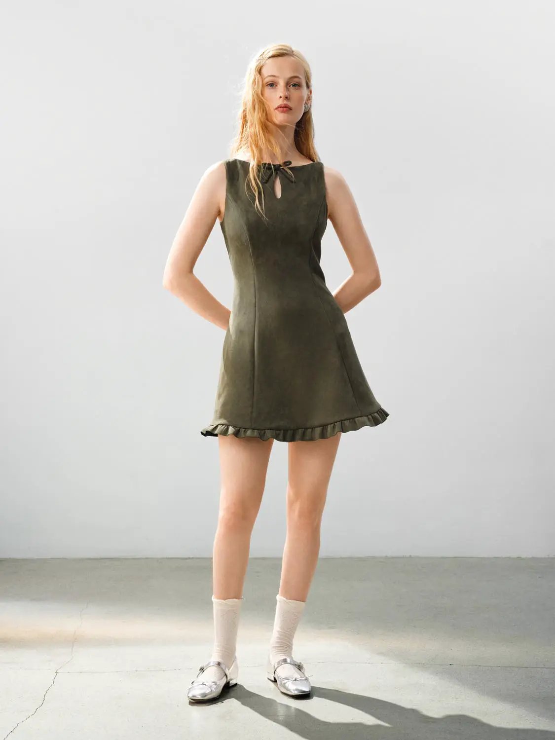Ruffle Hem Bow Detail Sleeveless A-Line Mini Dress in olive green with bow at neckline and ruffle hem.