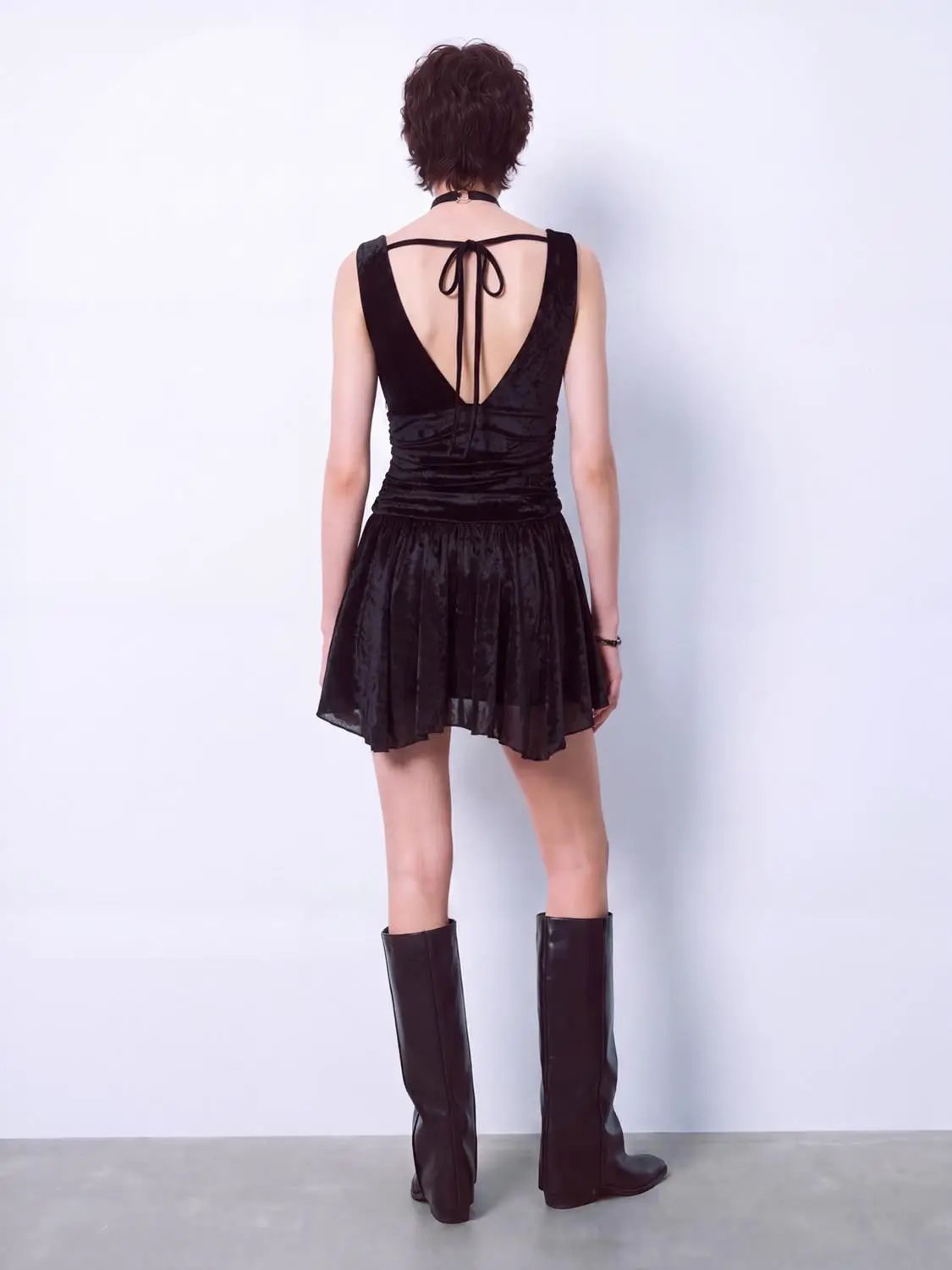 A-Line Dress in black velvet with open back and back-tie bow, ruched waist