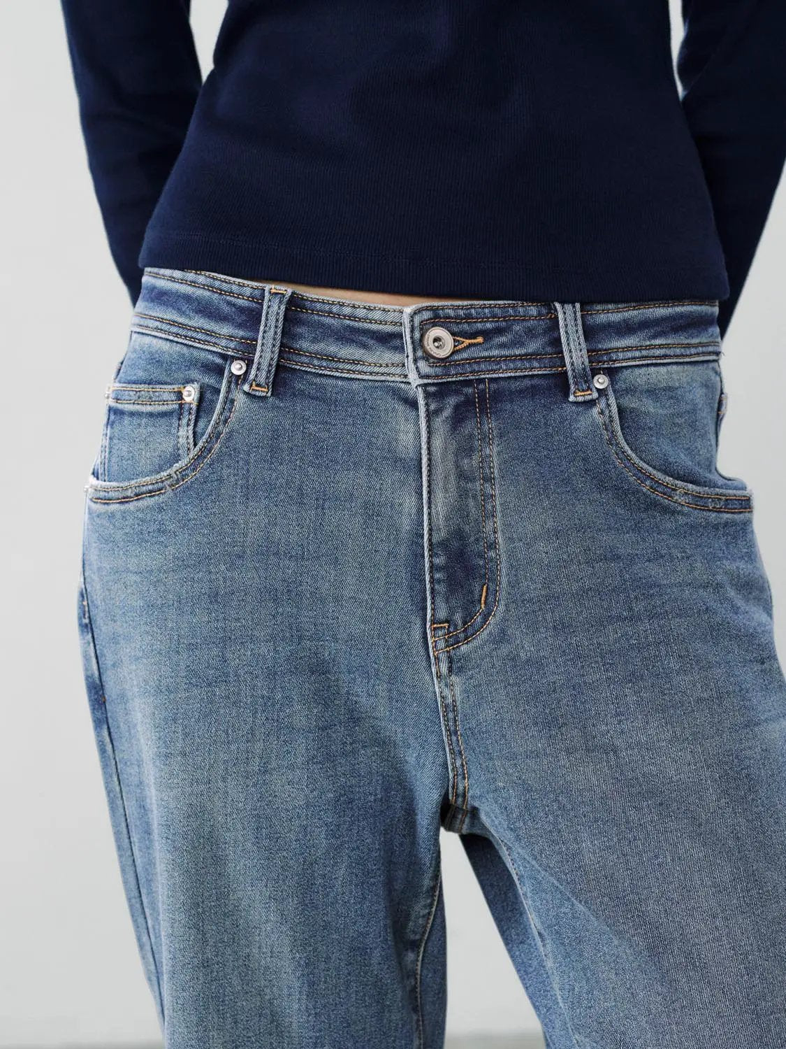 Jeans in faded blue feature a wide-leg, high-waisted cotton-blend design.