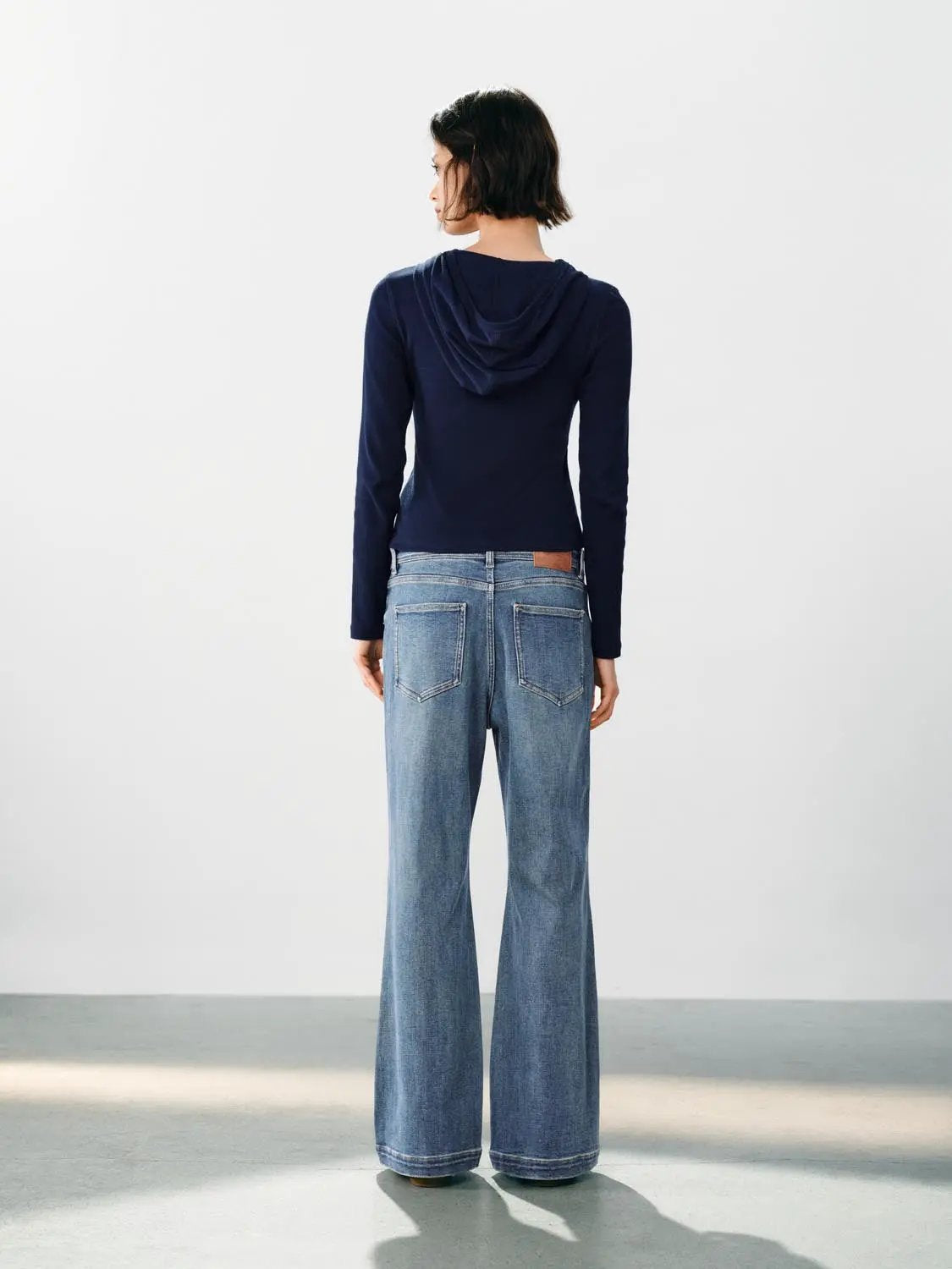 Faded blue wide-leg high-waisted cotton-blend jeans by Urban Revivo Fashion, back view on model.