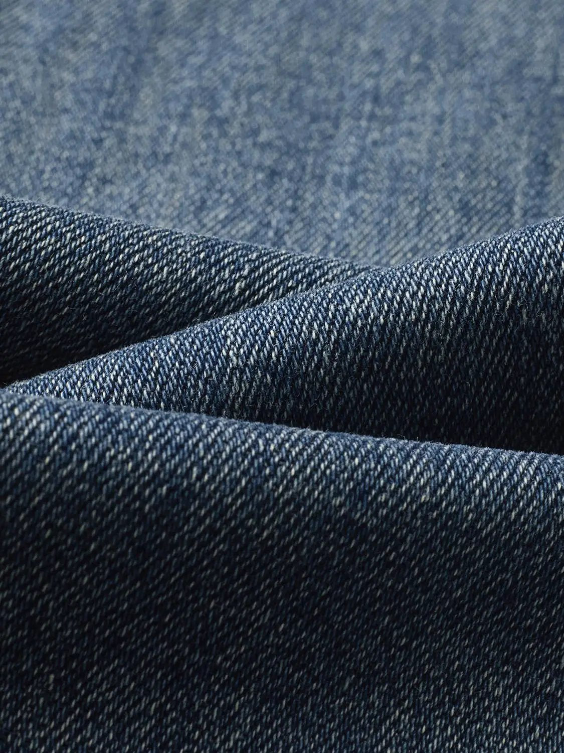 Faded blue wide-leg high-waisted cotton-blend jeans fabric close-up denim texture