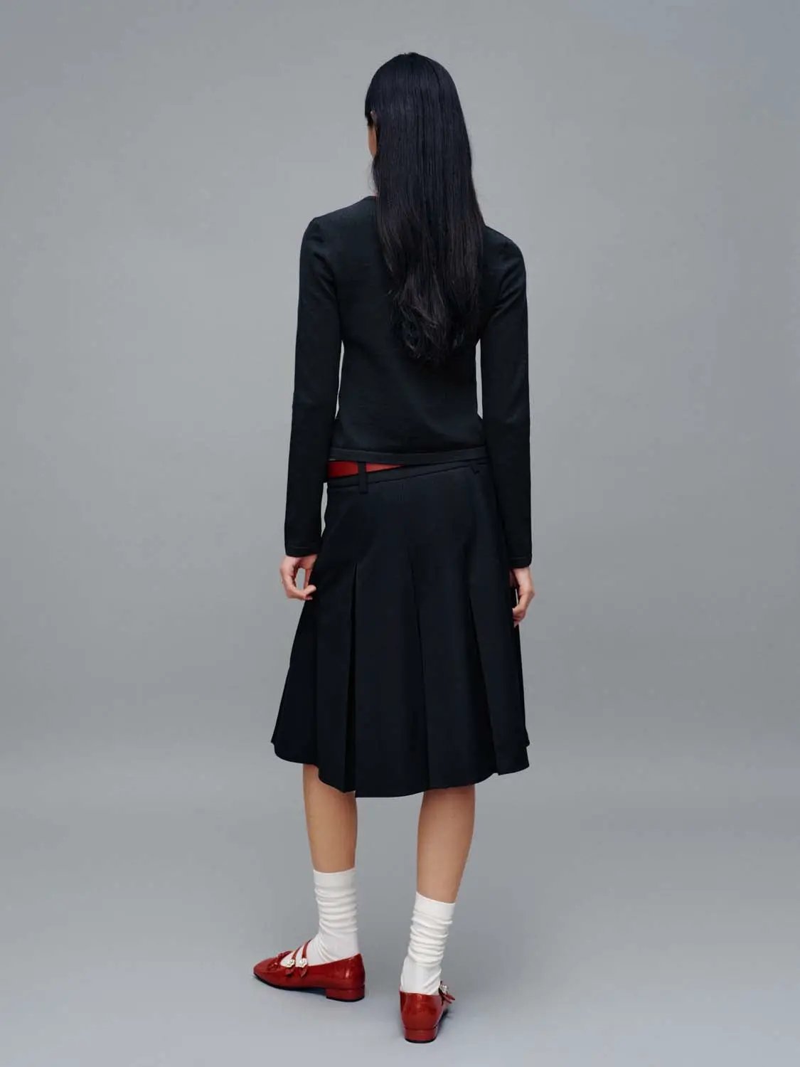 Crew Neck Embroidered Knitted Cardigans by Urban Revivo Fashion; model in black cardigan with black skirt (back view).