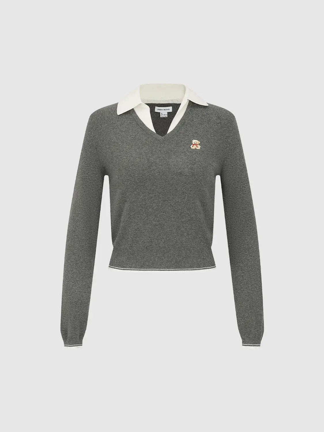 Knit T-shirt with white collared shirt peeking at neckline, grey knit top with small bear logo.