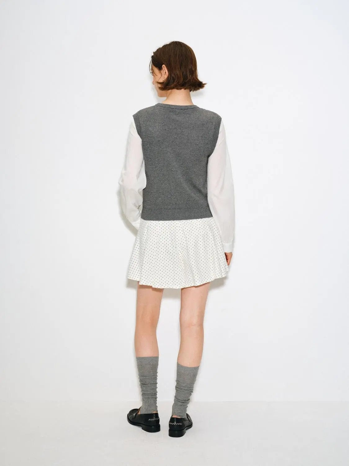 Knit T-Shirt, gray knitted top layered over white long-sleeve shirt with a white polka-dot skirt; three-piece outfit