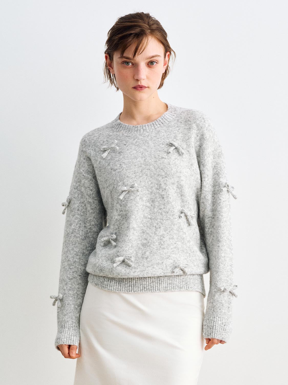 Knit T-Shirt: light gray knit sweater with bow embellishments on the front and sleeves