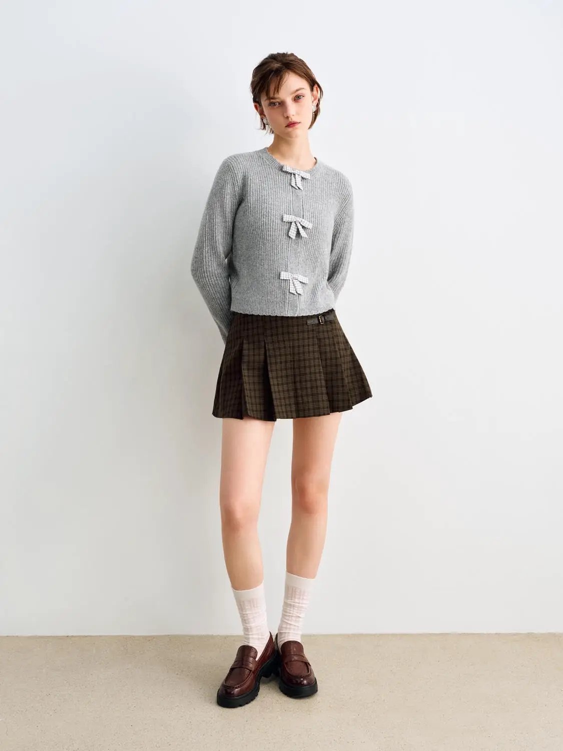 Knitted cardigan in gray with bow closures, paired with brown plaid pleated skirt (two-piece set)