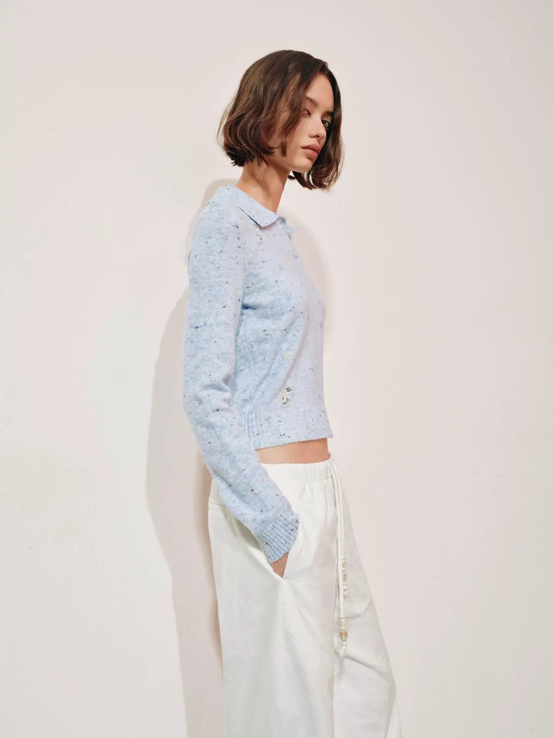 Embroidered floral knit polo-collar sweater, light blue speckled knit, cropped length, long sleeves.