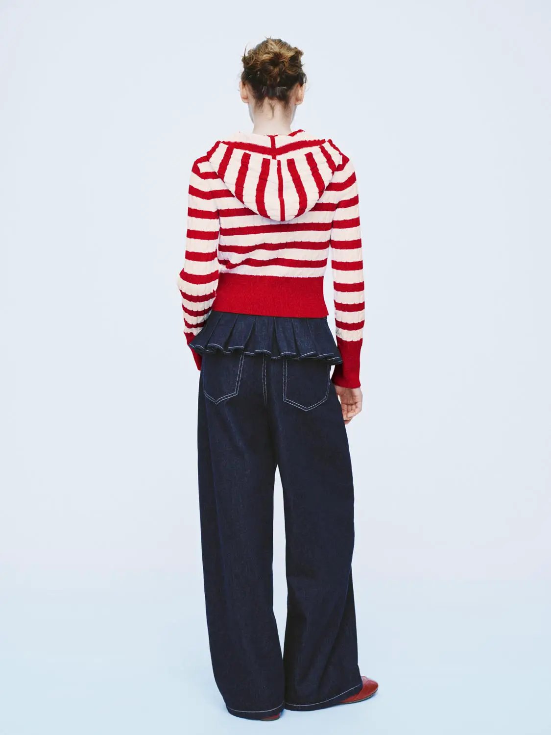 Knitted cardigan with hood; red and white stripes, red rib hem, back view.