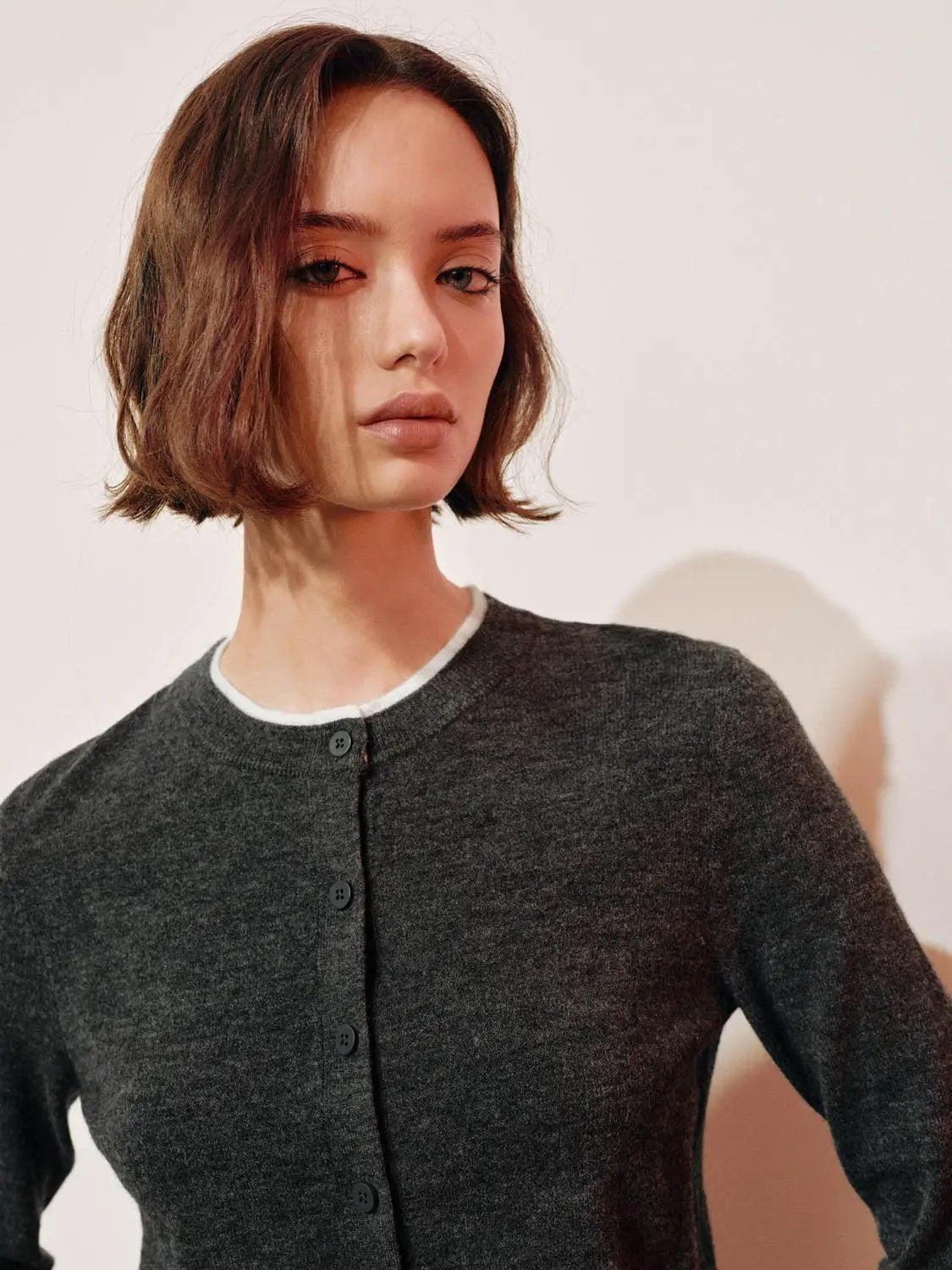 Knit cardigan in charcoal with button-front closure and long sleeves
