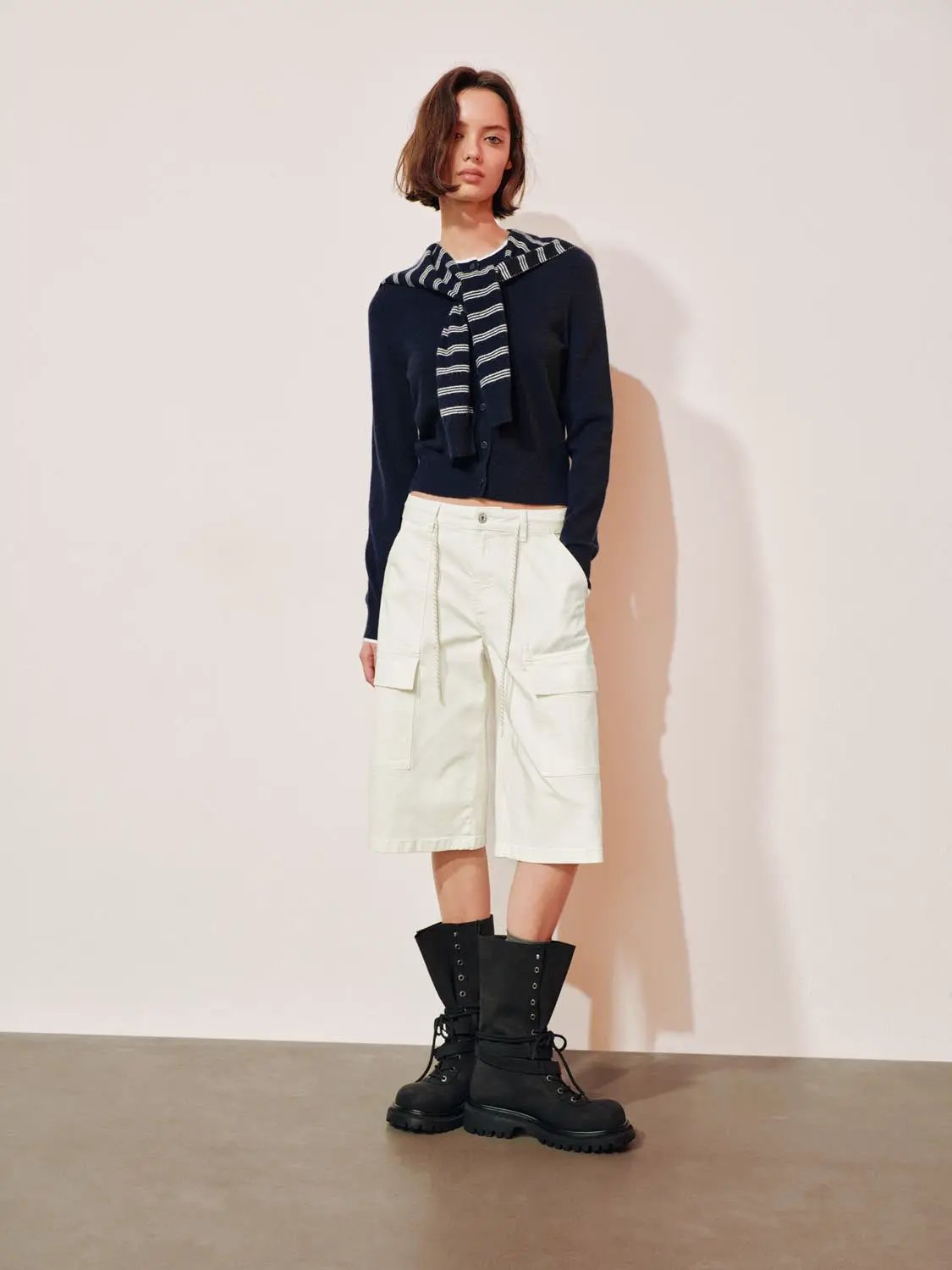 Womens knit striped shawl cardigan with button front, paired with white cargo shorts and black combat boots.
