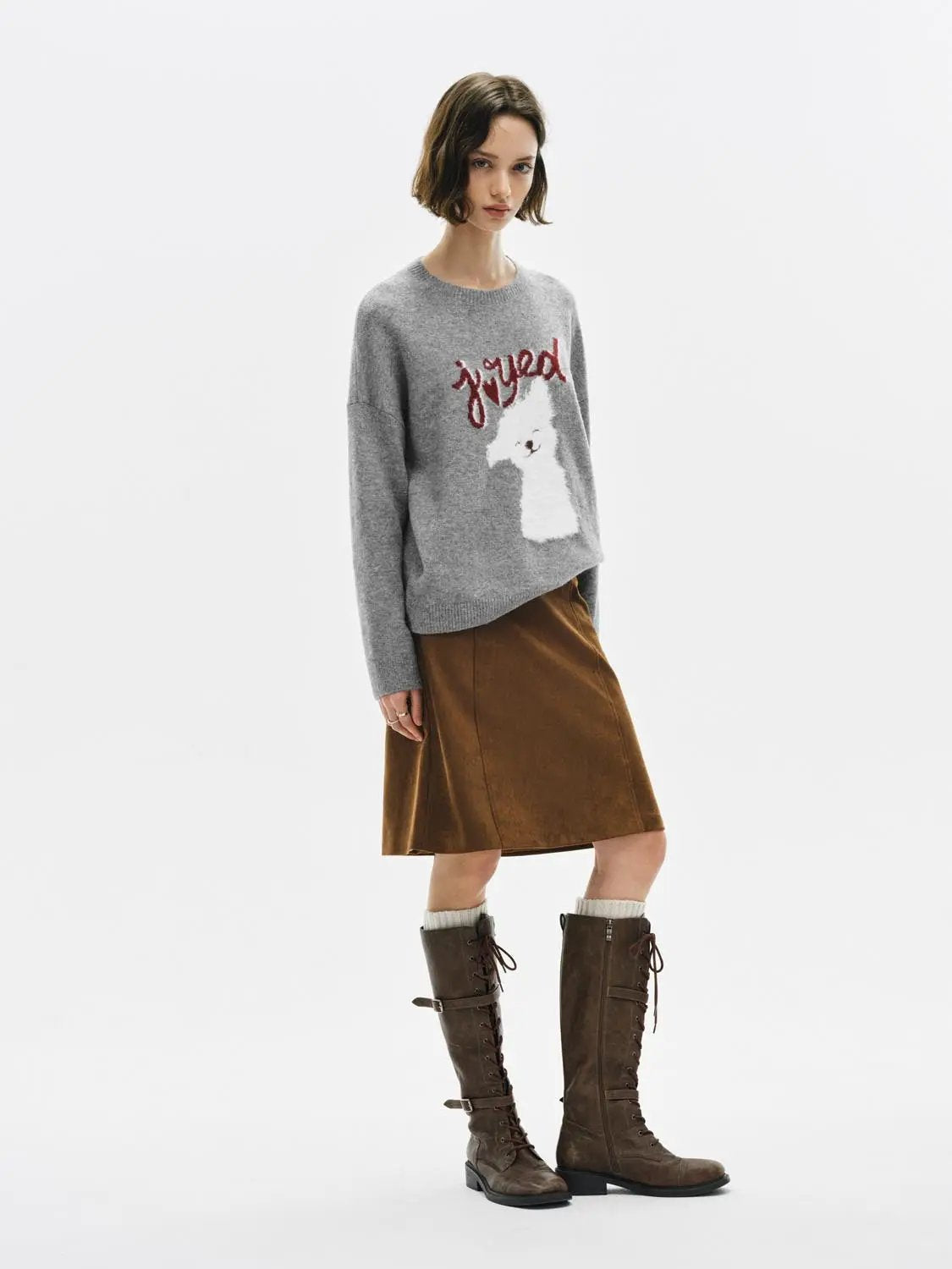 Knitwear T-shirt in gray knit with red graphic and white animal design; paired with brown suede skirt and tall boots
